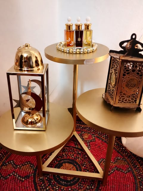 Perfume oils displayed on gold stands with lanterns