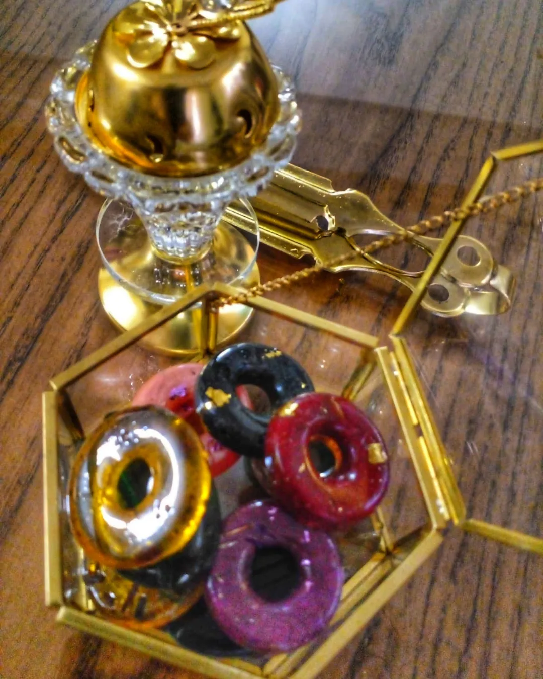 Gold mabkhara incense burner with a glass box of bakhoor discs