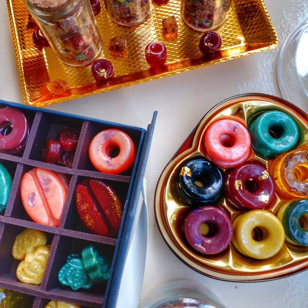 Colourful solid bakhoor discs in a tasting box